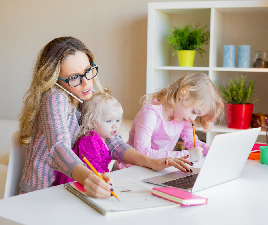 Manager reviewing employee time tracking reports on a laptop while working at home with kids